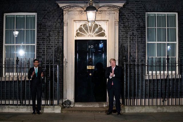 Prime Minister Boris Johnson of Britain applauding in support of the National Health Service in London on Thursday night.Credit...Aaron Chown Press Association, via Associated Press