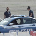 Tom and director Christopher on set near to the police cars