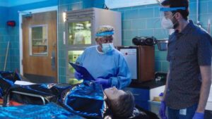 NCIS New Orleans Season 7 Episode 2 L-R CCH Pounder as Dr. Loretta Wade and Rob Kerkovich as Forensic Agent Sebastian Lund