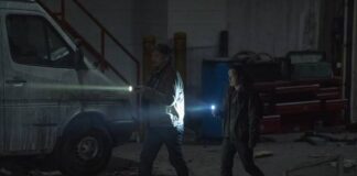The Last of Us Season 1 Episode 4 Recap THE LAST OF US Episode 4_ pedro-pascal-bella-ramsey holding the torch and walking Kansas City-
